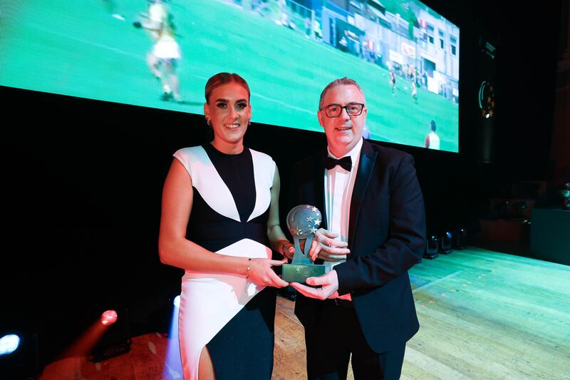 Down's Dearbhla Magee receives her Camogie Player of the Year award from Irish News sports editor Paul McConville