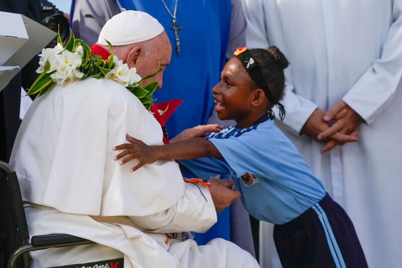 Pope Francis is hugged by a blind pupil from the Holy Trinity Humanistic School in Baro, near Vanimo, Papua New Guinea (Gregorio Borgia/AP)