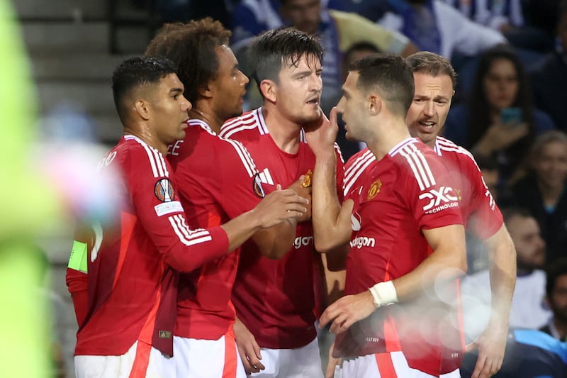 Harry Maguire, centre, celebrates his equaliser against Porto (Luis Vieira/AP)