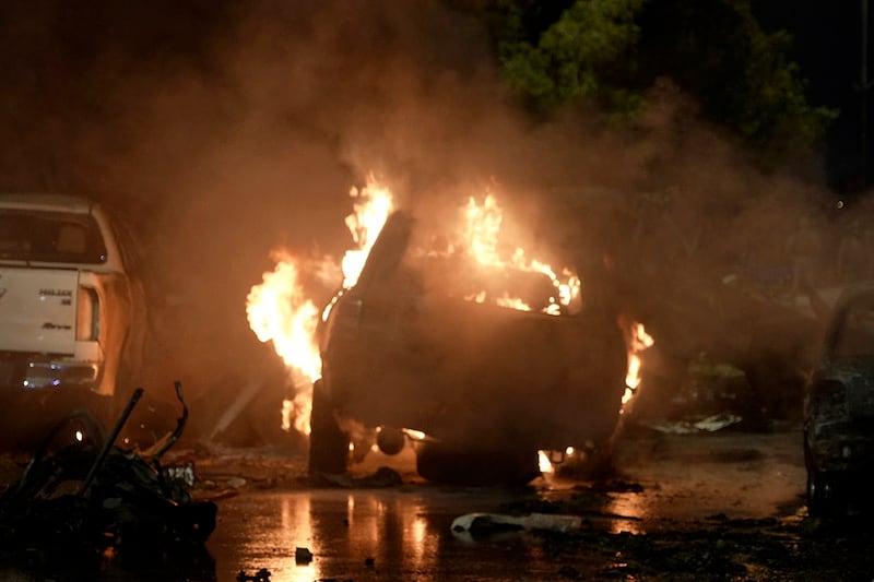 A vehicle on fire at the site of the explosion (Mohammad Farooq/AP)