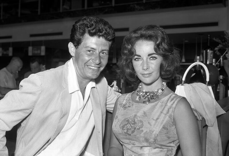 Singer Eddie Fisher with actress Elizabeth Taylor at London Airport in 1959