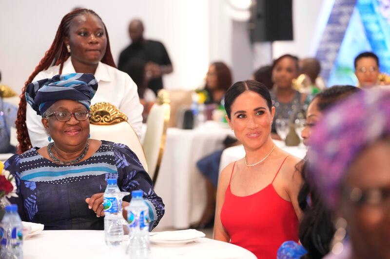 Meghan sits beside Ngozi Okonjo-Iweala, director general of the World Trade Organisation, during an event in Abuja, Nigeria (Sunday Alamba/AP)