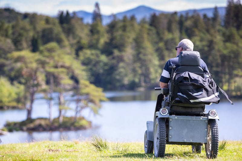 Visitor enjoying the view of the lake at Tarn Hows, Cumbria. (Chris Lacey/National Trust)