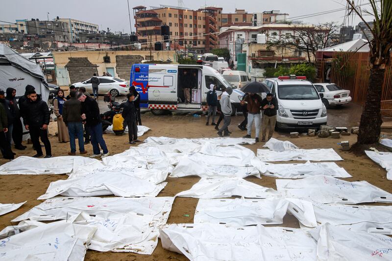 Palestinians look for the bodies of their relatives, who were killed in the Israeli bombardment of the Gaza Strip, at the Nasser hospital in Khan Younis (Jehad Alshrafi/AP)