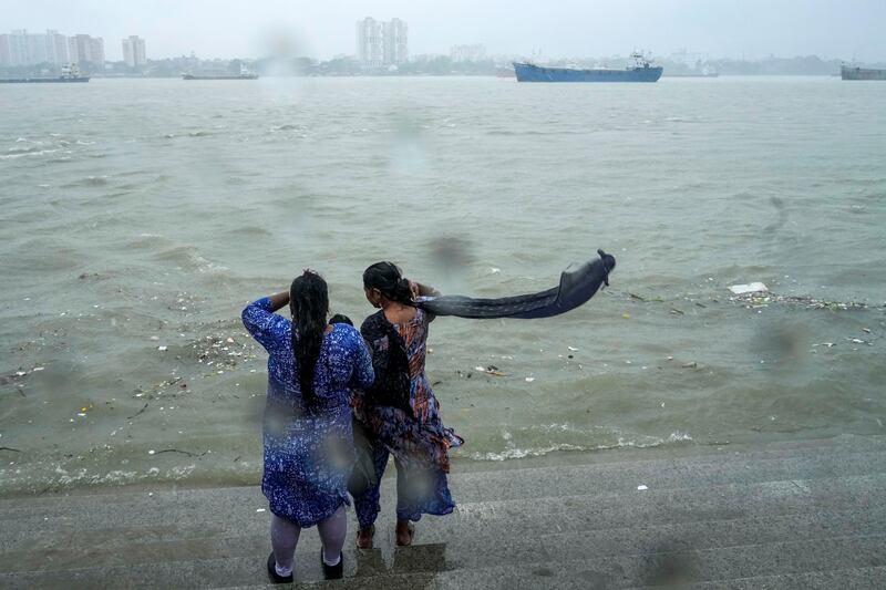 Onlookers watch a raging Hooghly River with high wind in Kolkata, India, as rain continues after cyclone Remal made a landfall near the Bangladesh-India border (Bikas Das/AP)