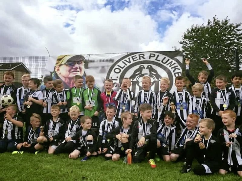 St Oliver Plunkett youth team celebrate under the watchful eye of the late Jackie Maxwell. The west Belfast club will celebrate its 50th birthday at Belfast&#39;s City Hall on September 7. Ticket information below. 