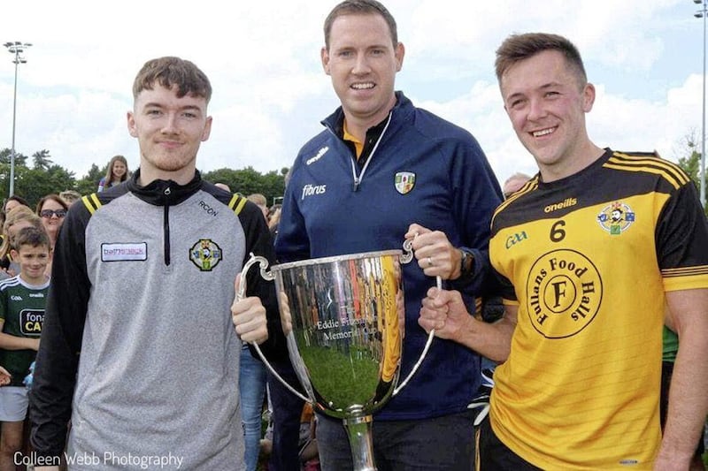 Portglenone joint captains Ryan Convery (left) and Niall Delargy accept the league title from club-mate and county treasurer Donal Murphy, the club&#39;s first in its 82-year history Picture courtesy of Colleen Webb 