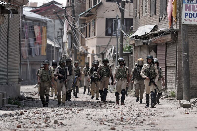 Members of the security forces patrol a rubble strewn street following violent clashes in Srinigar, Kashmir, 2016. Picture by Cathal McNaughton