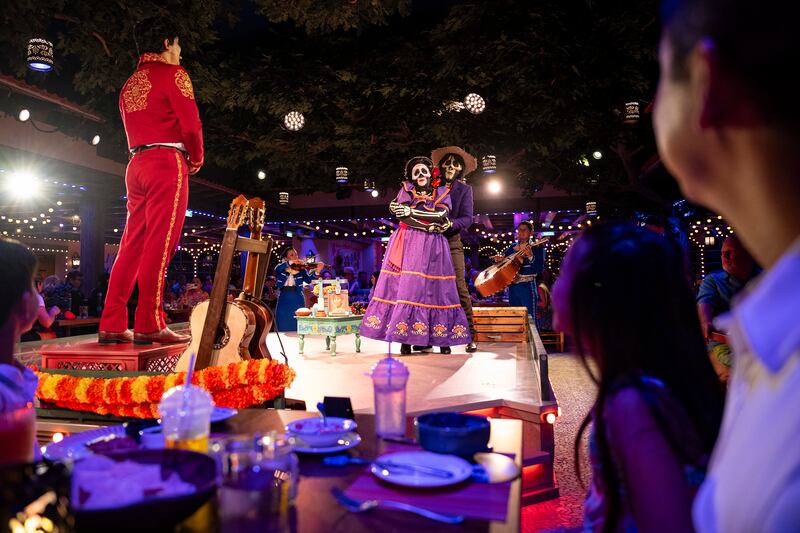 A scene from the Plaza De Coco theatrical dining experience themed to the film Coco on the Disney Treasure