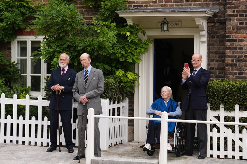 Prince Michael of Kent, the Duke of Kent, the Duchess of Kent and Lord Nicholas Windsor watch the three pipers outside Wren House