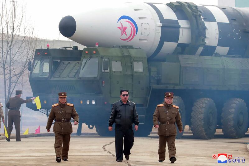 In this photo distributed by the North Korean government, North Korean leader Kim Jong Un, centre, walks near what it says is a Hwasong-17 intercontinental ballistic missile (ICBM) on the launcher at an undisclosed location (Korean Central News Agency/Korea News Service/AP)