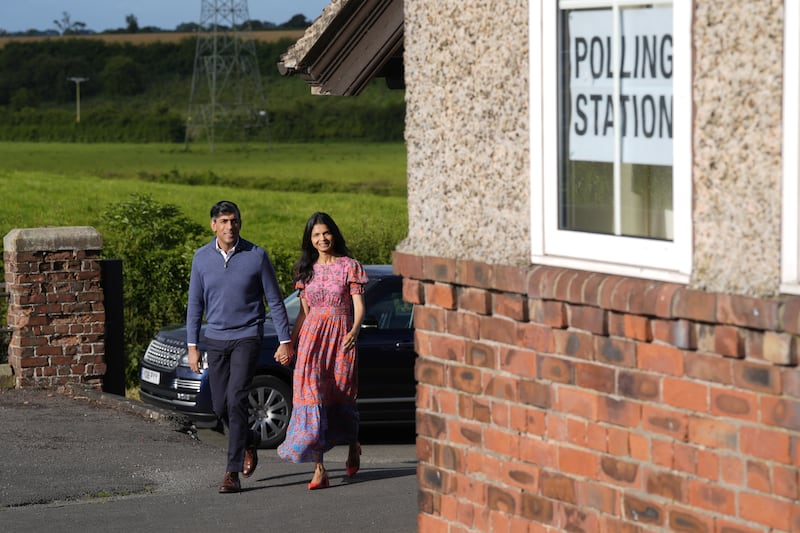 Prime Minister Rishi Sunak and his wife Akshata Murty arrive to cast their vote in the 2024 General Election at Kirby Sigston Village Hall in Northallerton