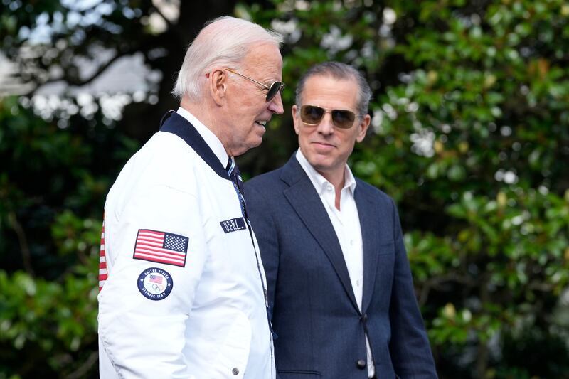 President Joe Biden, wearing a Team USA jacket and walking with his son Hunter Biden (Susan Walsh/AP)