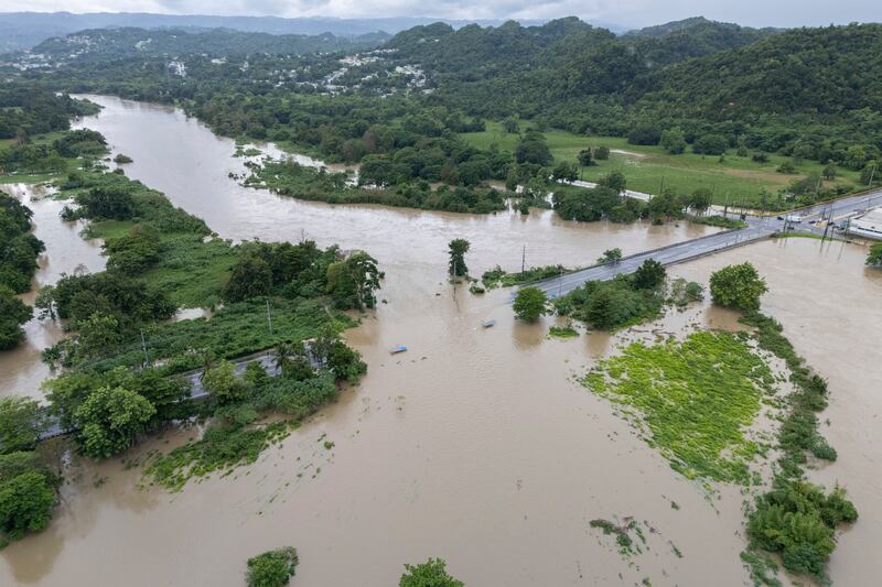 La Plata river floods a road after Tropical Storm Ernesto passed through Toa Baja, Puerto Rico (Alejandro Granadillo/AP)