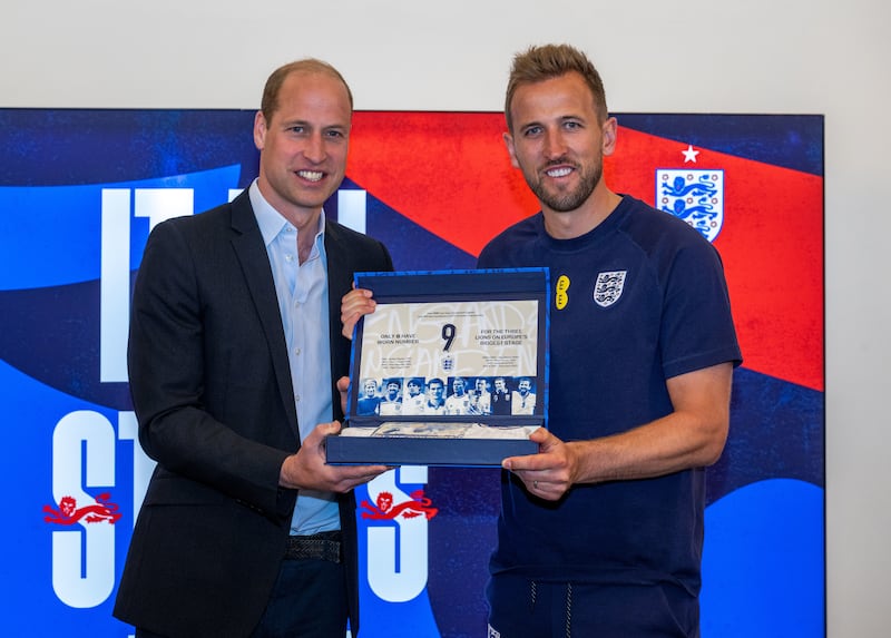 The Prince of Wales presents Harry Kane with a shirt during a visit to St George’s Park ahead of the UEFA Euro 2024 campaign