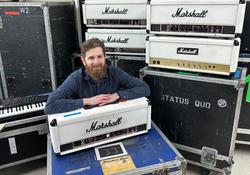 Auctioneer Luke Hobbs with the Status Quo’s equipment that is due to be sold