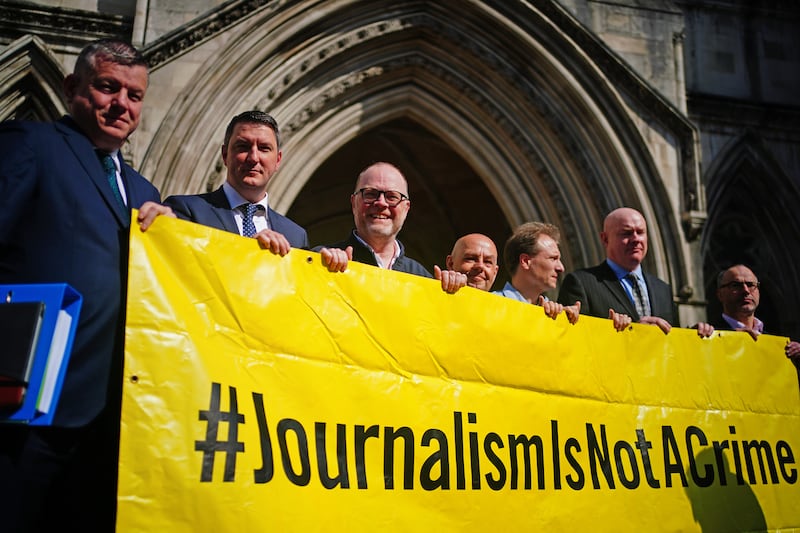 Barry McCaffrey, centre, and Trevor Birney, third left, with lawyers and supporters outside the Royal Courts of Justice in London .