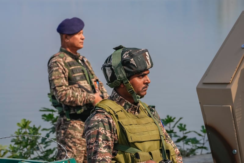 Paramilitary soldiers stand guard outside the venue of swearing in ceremony of ministers of Kashmir’s local government on the outskirts of Srinagar, Indian controlled Kashmir (Dar Yasin/AP)