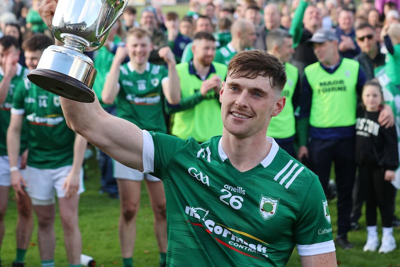 Carey captain Shea Hunter holds the cup aloft after his team's win over Glenarife Oisins in the final of the Antrim Intermediate Hurling Championship at Loughgiel. Picture: Aaron Alatas