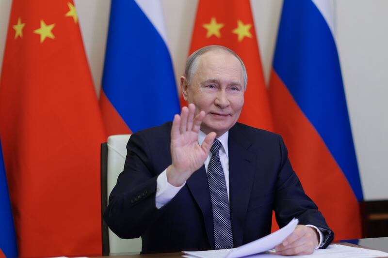 Russian President Vladimir Putin speaks with Chinese President Xi Jinping via video conference in Moscow (Gavriil Grigorov/AP)