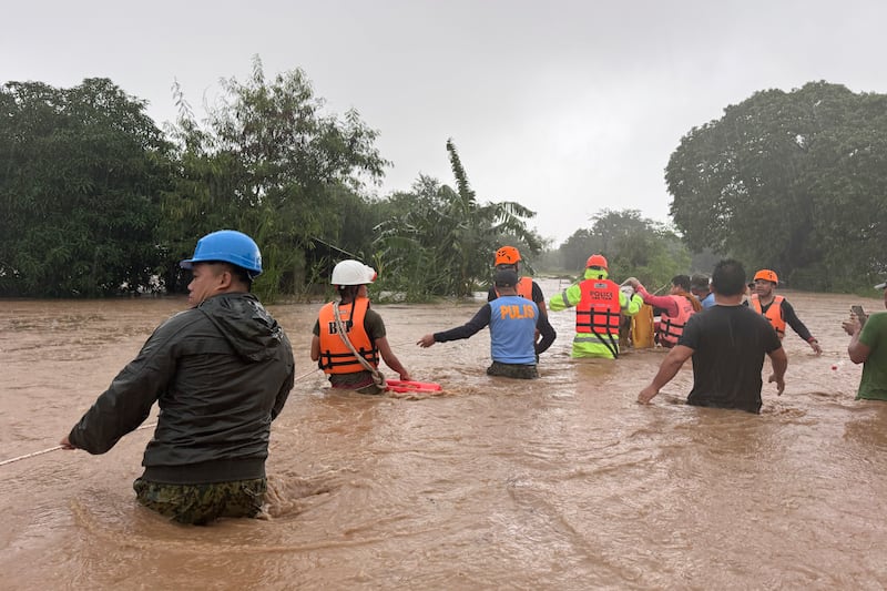 Filipino nationals fled floodwaters in September 2024, when the Asian nation was battered by Typhoon Krathon (Bernie Dela Cruz/AP)