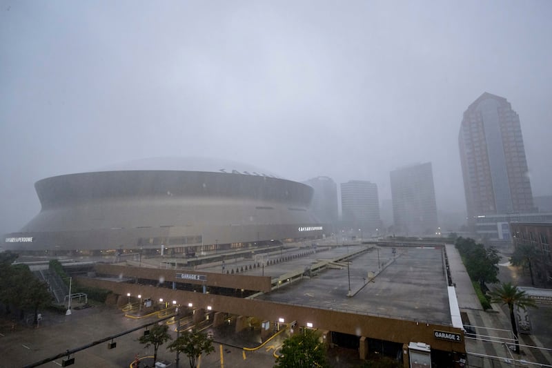 Rainfall from Hurricane Francine makes the white roof of the Caesars Superdome, left, difficult to see in New Orleans (Matthew Hinton/AP)