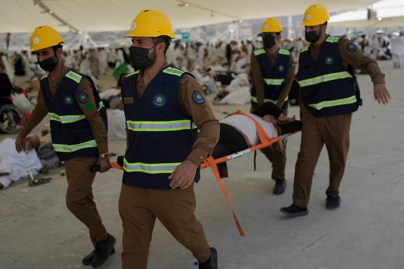 Paramedics carry a Muslim pilgrim for a medical check after he fell down due to a heat stroke at pillars, in Mina, near the holy city of Mecca, Saudi Arabia (Rafiq Maqbool/AP)