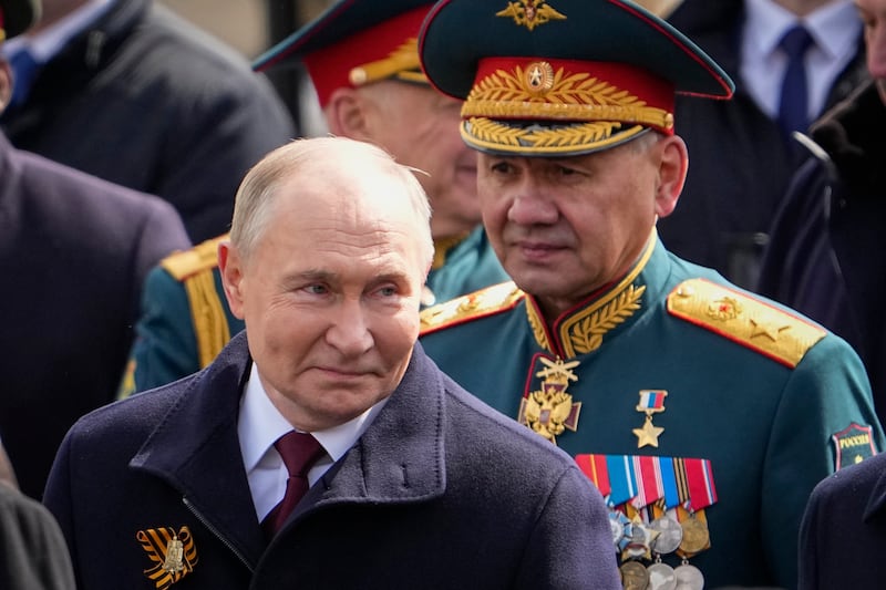 Russian President Vladimir Putin, left, and Russian Defence Minister Sergei Shoigu leave Red Square after the Victory Day military parade in Moscow (Alexander Zemlianichenko/AP)