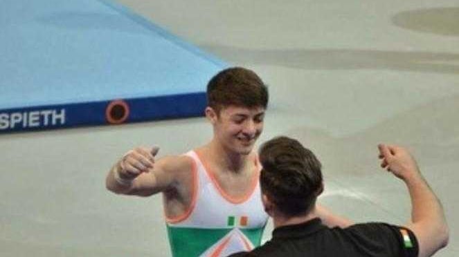 Rhys embraces his coach after completing his routine in the Junior European Championships  