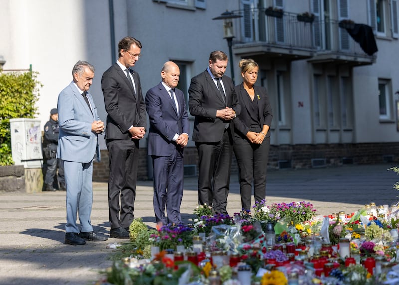 German Chancellor Olaf Scholz and other officials pay their respects to the victims of the knife attack in Solingen (Thomas Banneyer/dpa/AP)