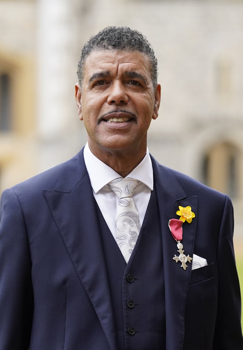 Chris Kamara wearing his MBE medal