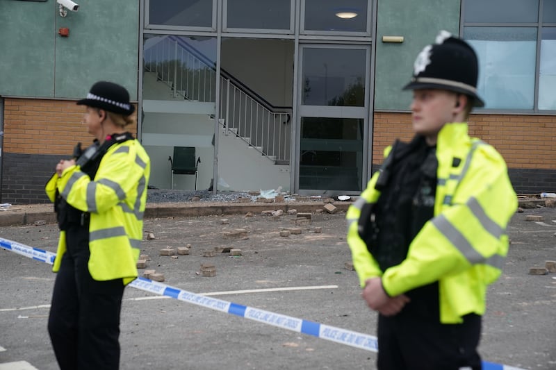 Police officers at the scene of the disorder the following day