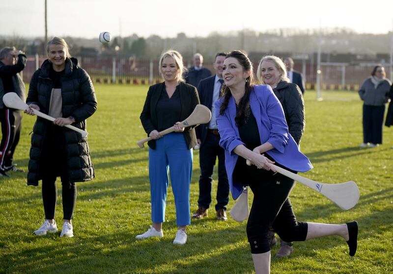 Northern Ireland First Minister Michelle O’Neill, centre, deputy First Minister Emma Little-Pengelly, right, and junior minister Aisling Reilly, left, during a visit to St Paul’s GAA club in west Belfast