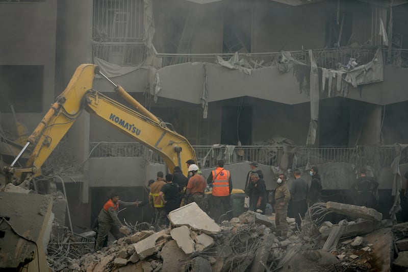 Rescue workers are searching for victims at the site of the air strike in central Beirut (AP Photo/Hassan Ammar)