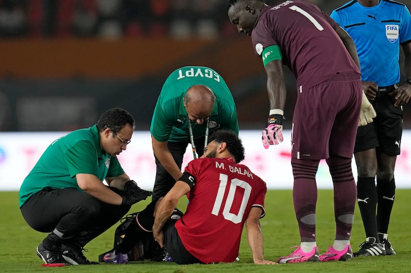 Egypt’s Mohamed Salah receives medical treatment before being substituted during the Africa Cup of Nations Group B soccer match between Egypt and Ghana (Themba Hadebe/AP)