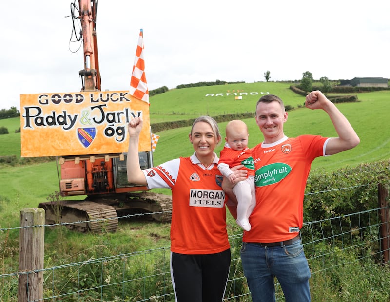 Gerard Loye with his wife Niamh and daughter Molly , Who made a sign in support of Armagh.
PICTURE COLM LENAGHAN