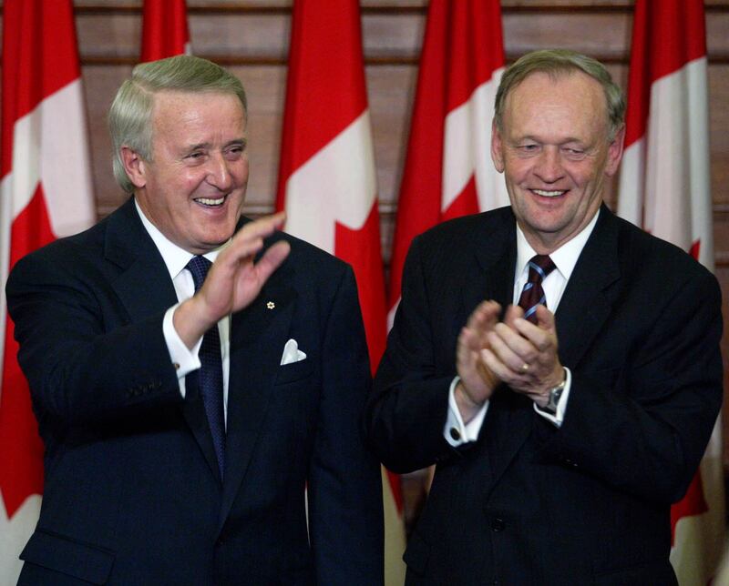 Canadian Prime Minister Jean Chretien, right, applauds former prime minister Brian Mulroney during an official unveiling ceremony of Mulroney’s official portrait on Parliament Hill in Ottawa, Ontario in 2002 (Tom Hanson/The Canadian Press via AP)