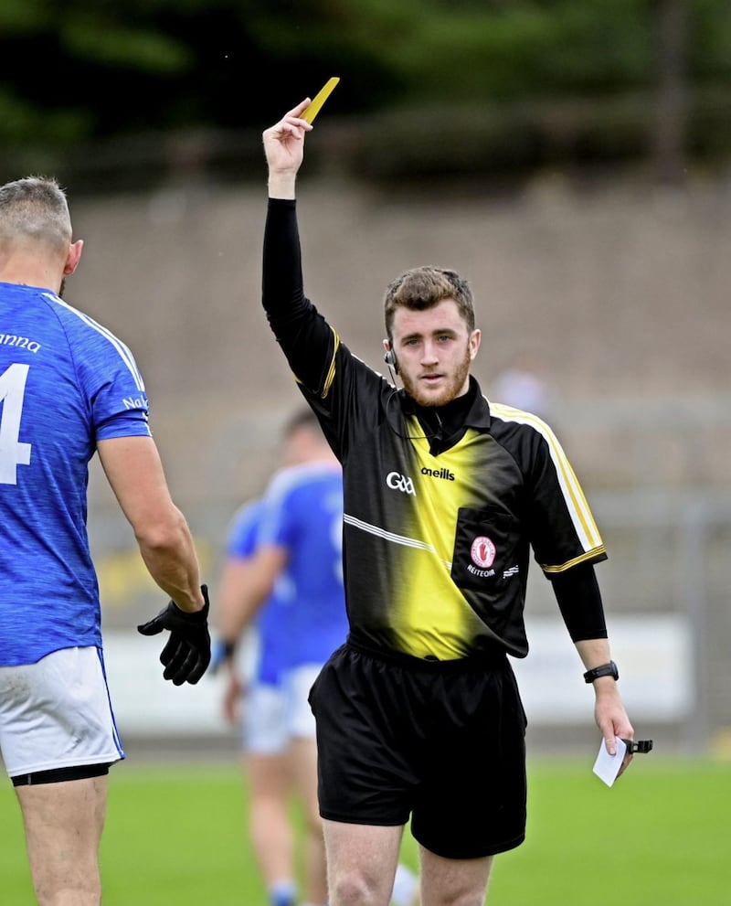 Tyrone referee Martin Coyle, dishes out a yellow card during his first championship match on Saturday. 