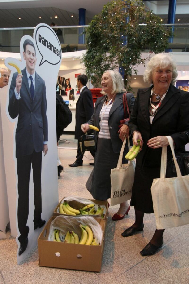 Delegates pick up free David Miliband bananas, which are on offer as they arrive ahead of second day of the Conservative Party Conference