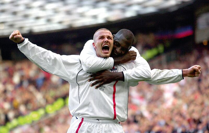 England’s captain David Beckham, front, celebrates with team-mate Emile Heskey after scoring the equaliser from a free-kick against Greece in a World Cup qualifier