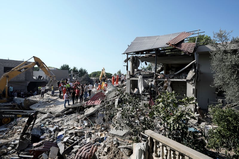 Emergency workers arrive at the scene of an Israeli airstrike in the town of Maisara, north of Beirut, on Wednesday (Bilal Hussein/AP)