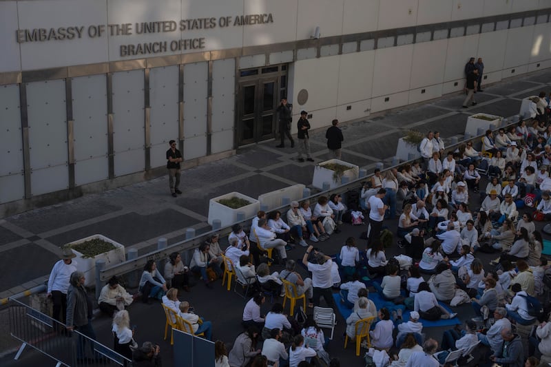 People sit in front of the US Embassy branch office in Tel Aviv, Israel, during a protest against Prime Minister Benjamin Netanyahu’s government and call for the release of hostages held in the Gaza Strip on Wednesday (Ohad Zwigenberg/AP)