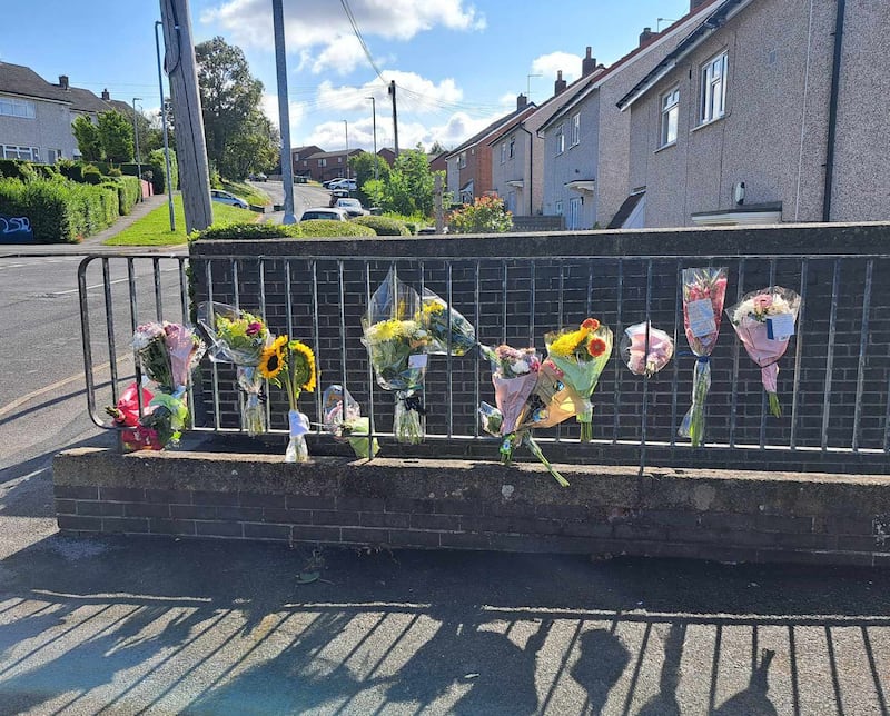 Floral tributes were left at the scene in Heights Drive, Wortley, Leeds