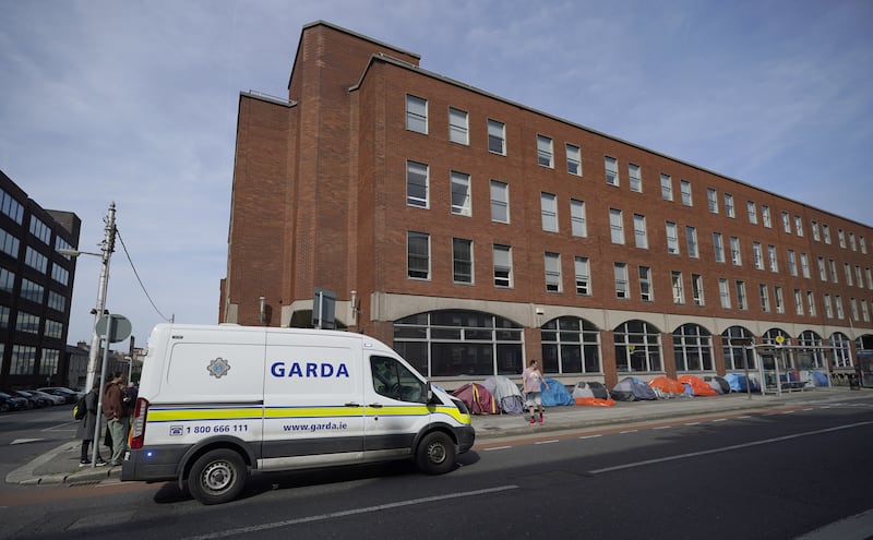 Public order gardai by tents outside the International Protection Office in May