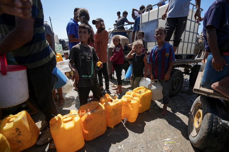 Displaced Palestinians line up for water in Deir al Balah, central Gaza Strip (Abdel Kareem Hana/AP)