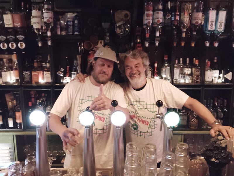 Wearing T-shirts from the Sunflower in Belfast, barmen in the village of Vijfhuizen near Amsterdam. PICTURE: PEDRO DONALD