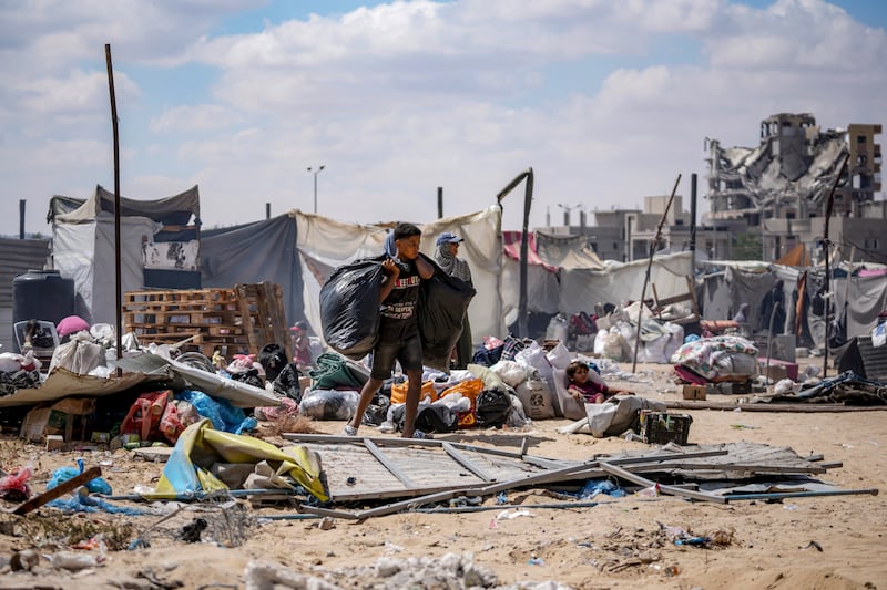 Palestinians displaced by the Israeli air and ground offensive on the Gaza Strip flee from Hamad City