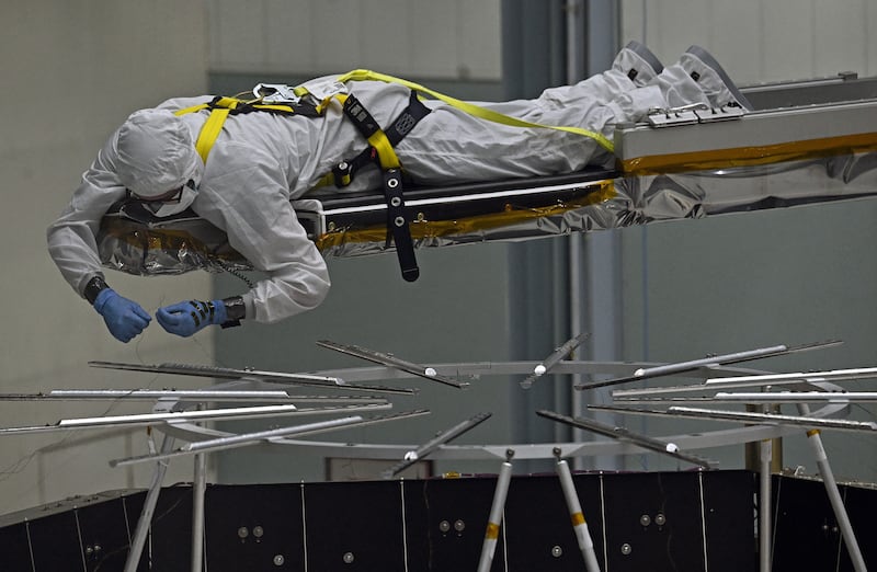 A worker in a clean suit labors on the assembly of the Roman Telescope. PICTURE: Michael S. Williamson/The Washington Post