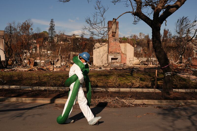 A member of the California Conservation Corps works amid the rubble following the Palisades Fire (Jae C Hong/AP)