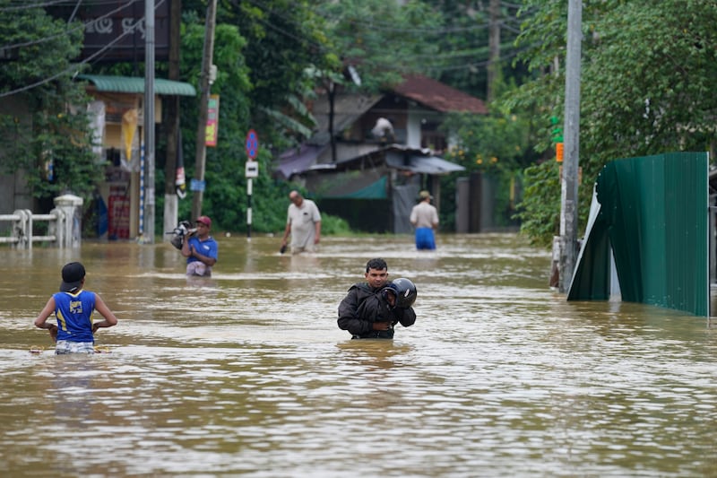 Flood waters in Kelaniya, Colombo, on Monday (Eranga Jayawardena/AP)